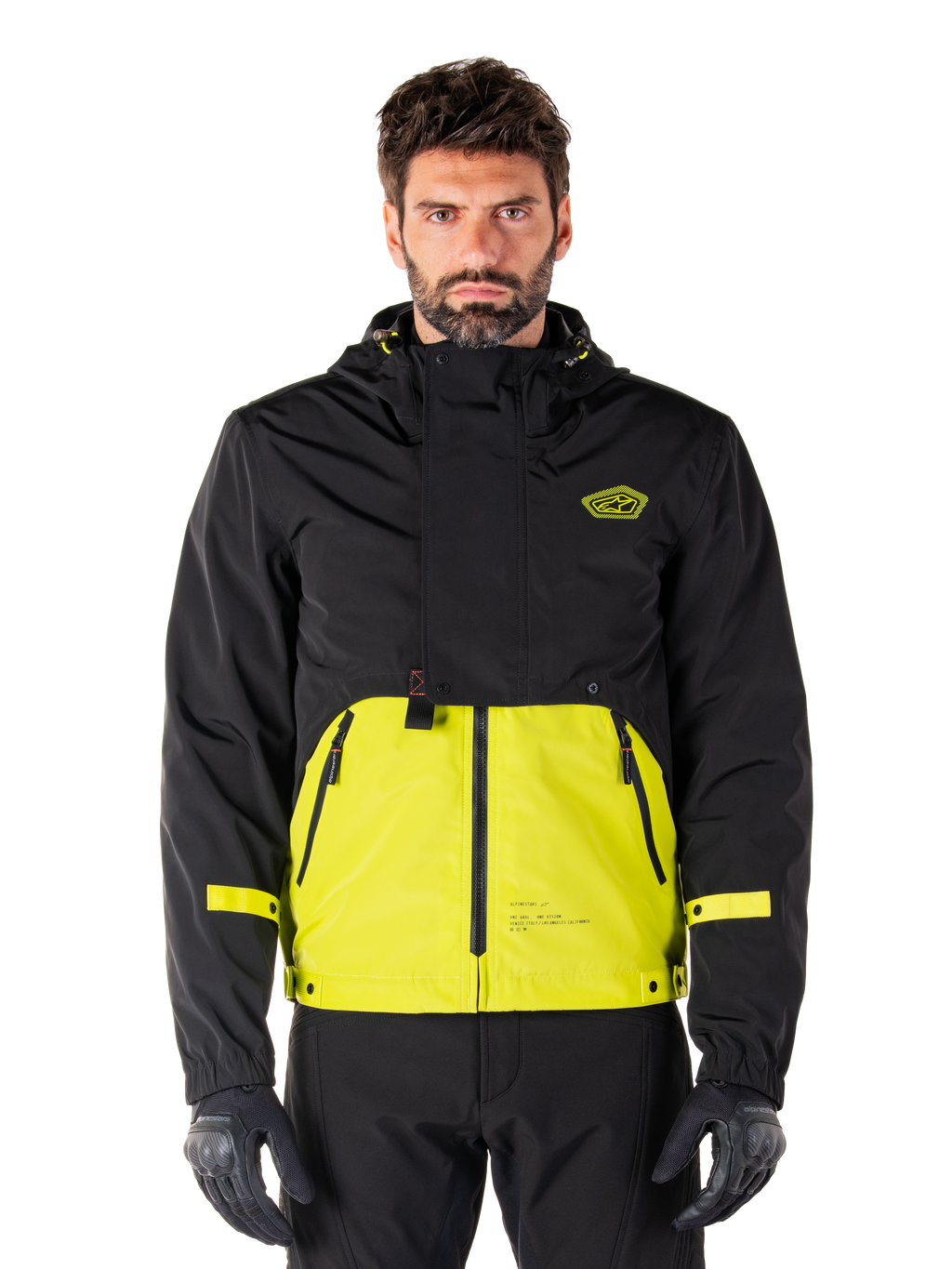 Alpinestars Mootant Waterproof Parka, chaqueta de motociclismo Touring, color Lime Punch y negro, diseño bicolor con capucha, parte inferior en amarillo brillante y parte superior negra, correas amarillas en las mangas, logotipo en el pecho, estilo técnico modular