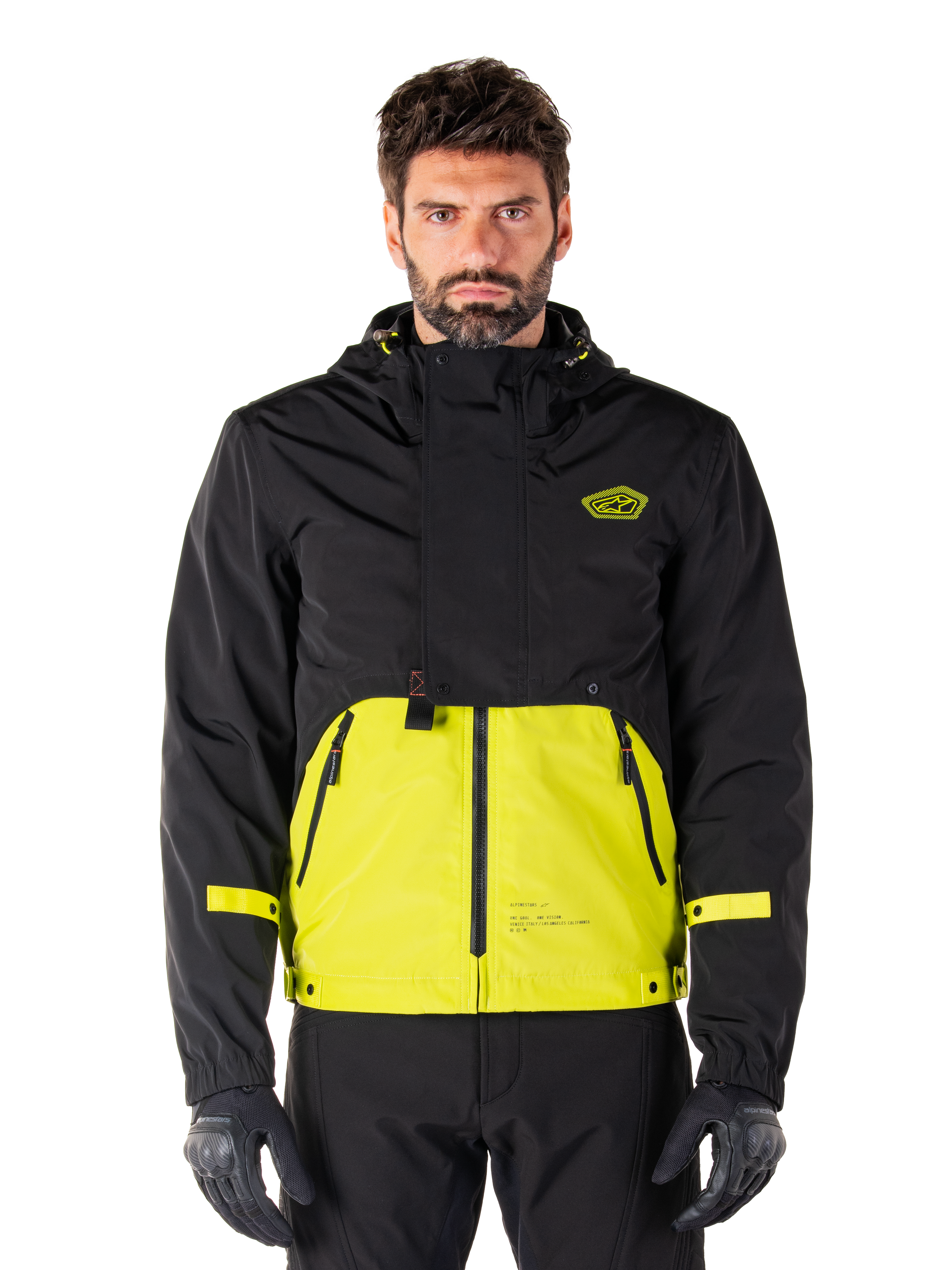 Alpinestars Mootant Waterproof Parka, chaqueta de motociclismo Touring, color Lime Punch y negro, diseño bicolor con capucha, parte inferior en amarillo brillante y parte superior negra, correas amarillas en las mangas, logotipo en el pecho, estilo técnico modular