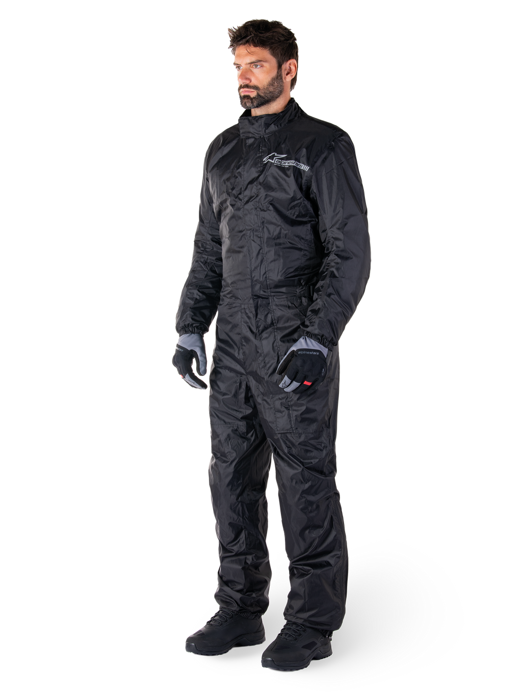 Mono Alpinestars Hurricane Rain V2, negro, traje de lluvia para moto de una sola pieza e impermeable, usado con guantes y botas, con el logotipo reflectante de Alpinestars en el pecho, diseño ligero para protección en climas húmedos