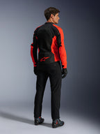 Alpinestars Viper Air V4 Jacket, Red Fluo Black, rear view on model, featuring technical mesh panels and a red star logo on the lower back, paired with black motorcycle pants and gloves for a complete road riding look.