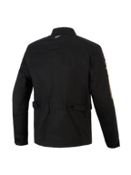 Alpinestars Dice Jacket, Black urban motorcycle jacket, back view showing waist adjustment straps and pleated shoulders, vintage field jacket aesthetic with modern textile construction, featuring a small white logo on the collar and gold branding on the sleeve.