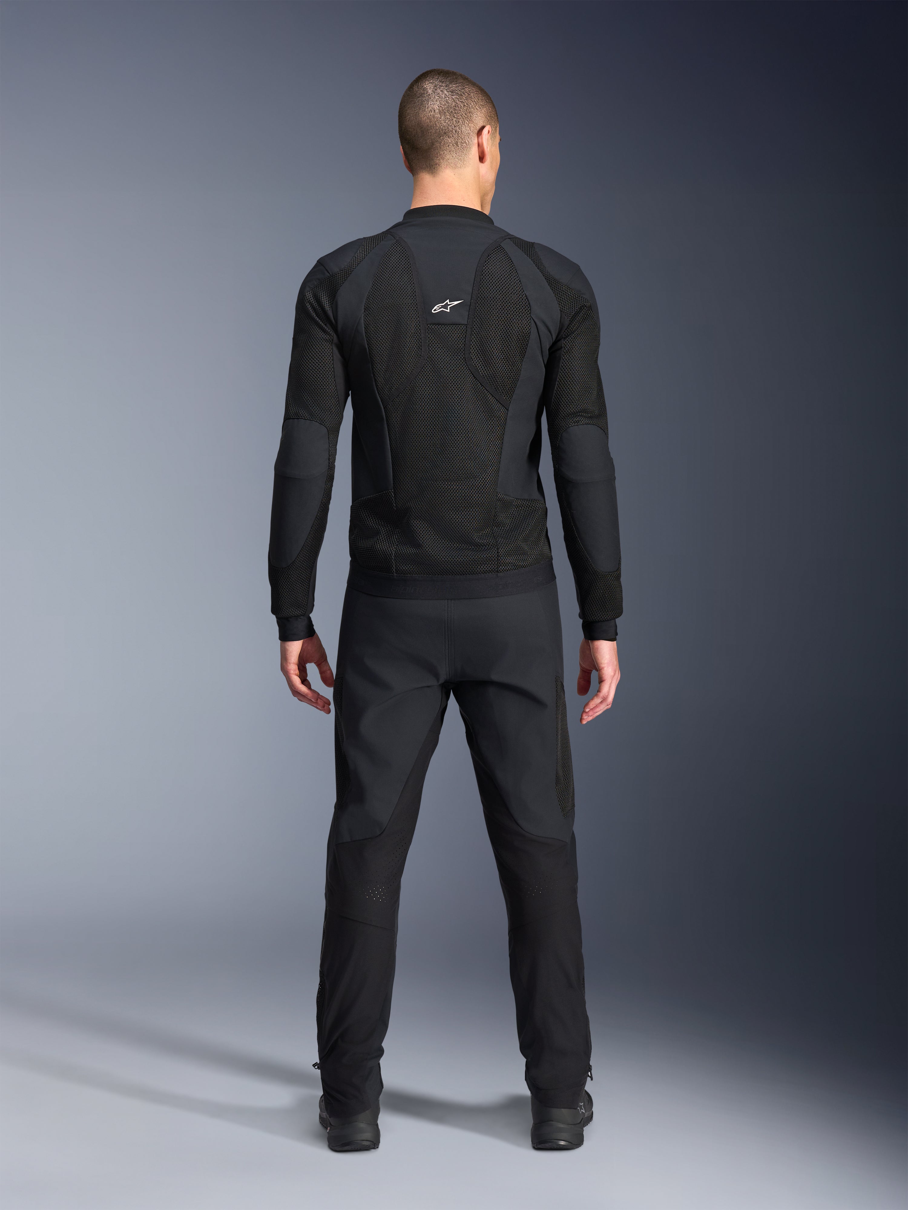 Alpinestars Troop-Air Pro Jacket, Back view, Black, technical motorcycle air jacket featuring large mesh ventilation panels and a white Alpinestars logo, paired with black pants, urban contemporary riding gear