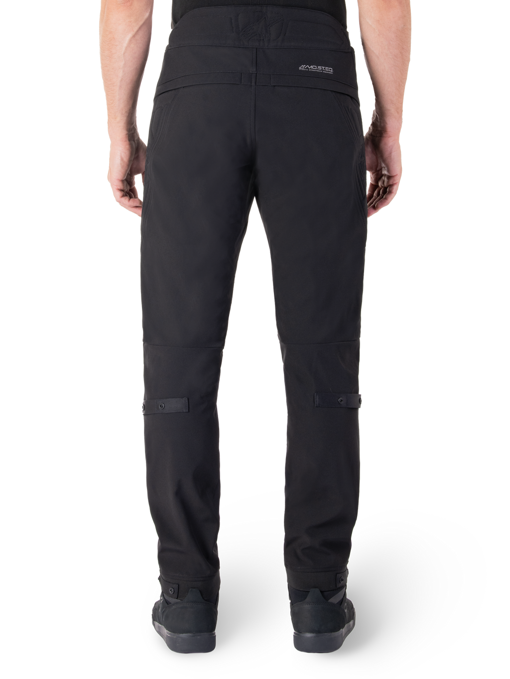 Alpinestars Alden Pants, Black Urban Motorcycle Pants, rear view, featuring reflective MO.ST.EQ. wordmark on the back yoke, slim fit below the knee, and snap button volume adjusters on the calves and cuffs, streetwear-inspired technical textile design.