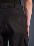 Close-up of Alpinestars Flex-AST Cargo Pants in Black, urban motorcycle pants featuring a detailed rear pocket with subtle branding, large belt loops, and a side cargo pocket on durable stretch textile.
