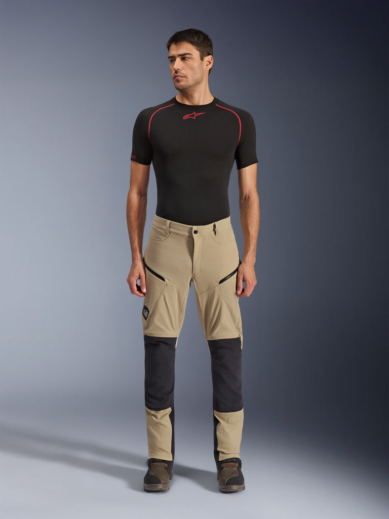 Alpinestars Flex-AST Explorer Pants, Beige and Black, motorcycle touring pants with reinforced knee panels and zippered pockets, worn in relaxed stance