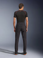 Alpinestars Flex-AST Canvas Pants, Urban Motorcycle Pants, Black, Rear view showing workwear-inspired design with back pockets and extended back rise, worn with a black base layer and sneakers, ergonomic ride fit