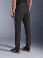 Alpinestars Flex-AST Canvas Pants, Black, rear view showing heritage workwear design with large back pockets, ergonomic urban riding fit, worn with black Alpinestars sneakers.