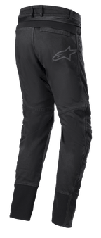 Pantalones Alpinestars SP Pro, pantalones técnicos deportivos para moto en color negro, vista trasera que muestra la cremallera de conexión en la cintura, inserciones elásticas RIDEKNIT en el canesú trasero y las pantorrillas, y logotipo sutil.