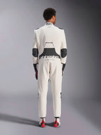 Rear view of a model wearing the Alpinestars Hypertech V3 Suit in White Black Silver, showcasing the large black lumbar stretch panel with 'alpinestars' and 'RACING AHEAD' branding, black elbow inserts, FIA certification label on the collar, and an athletic-slim fit designed for professional racing.