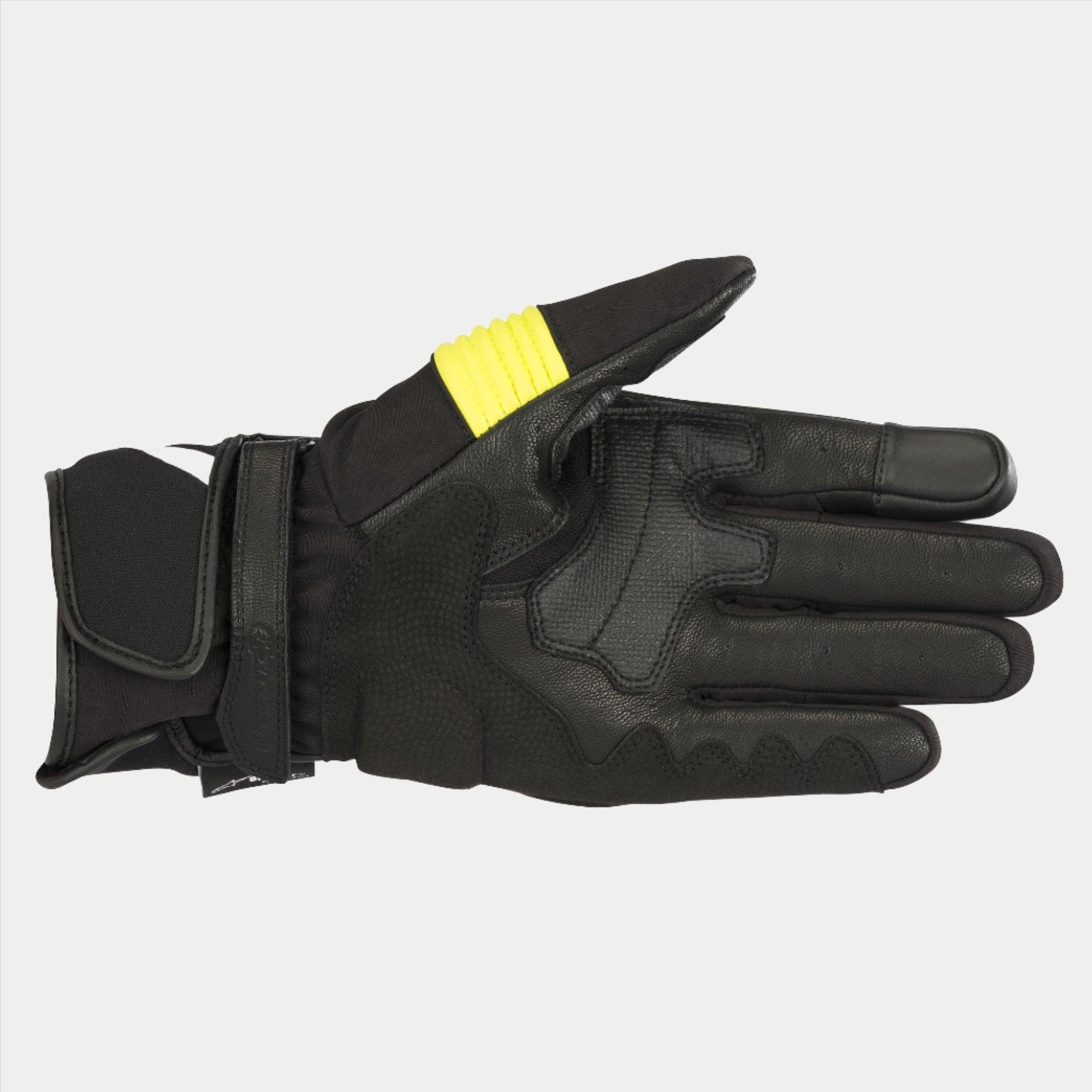 Guantes Alpinestars T-SP W Drystar®, negro y amarillo flúor, vista de la palma que muestra la construcción en piel de cabra con detalles en amarillo fluorescente en el pulgar, puntas de los dedos compatibles con pantallas táctiles y doble cierre de velcro en la muñeca.