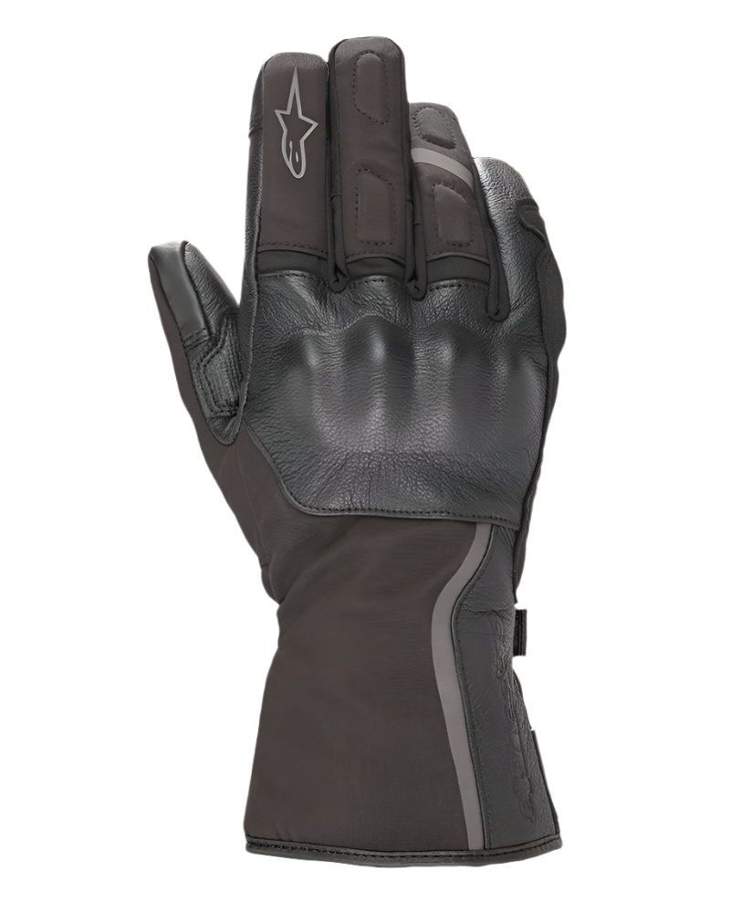 Alpinestars Stella Tourer W-7 Drystar® Gloves, guantes para mujer, negros, vista del dorso con protección de nudillos rígida recubierta de cuero, puño largo de turismo con ribete reflectante, logotipo Alpinestars en el dedo índice, confeccionados en tejido impermeable y cuero.
