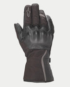 Guantes Alpinestars Stella Tourer W-7 Drystar® para mujer, negros, guantes de moto de invierno estilo guantelete con construcción de cuero y softshell, con protección rígida en los nudillos recubierta de cuero, detalles plateados reflectantes y logotipo de Alpinestars en el dedo.