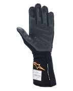 Guantes Alpinestars Tech-1 ZX V4, guantes de automovilismo, negro y naranja fluo, vista de la palma que muestra el patrón de agarre de silicona 3D y la textura de panal, etiquetas de homologación FIA y SFI visibles en el puño, equipo profesional de automovilismo