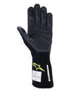 Guantes Alpinestars Tech-1 ZX V4, guantes de automovilismo, gris tar y negro con logo amarillo flúor, vista de la palma que muestra el agarre de silicona 3D texturizado y etiquetas de certificación de seguridad FIA/SFI, equipamiento profesional para automovilismo