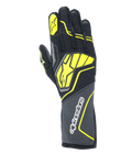 Guantes Alpinestars Tech-1 ZX V4, guantes de automovilismo, gris alquitrán, negro y amarillo fluorescente, con un gran logotipo de estrella amarilla en el dorso y marca blanca en el puño, tejido con textura de panal con detalles neón angulares, equipo profesional de automovilismo