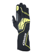 Guantes Alpinestars Tech-1 KX V4, guantes de karting, gris, negro y amarillo fluorescente, vista del dorso con construcción de malla transpirable, logotipo grande de Alpinestars en amarillo, nombre de la marca en blanco en la muñeca, estrella amarilla en el dedo índice, diseño deportivo moderno