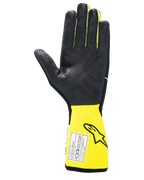 Guantes Alpinestars Tech-1 Race V4, guantes de automovilismo, negro y amarillo flúor, vista de la palma con agarre de silicona texturizada, puño amarillo extendido con etiqueta de certificación FIA, equipo de alto rendimiento para automovilismo