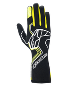 Guantes Alpinestars Tech-1 Race V4, guantes de carreras para automovilismo, negros con detalles en amarillo flúor y blanco, con un gran logotipo de estrella en el dorso y una estrella más pequeña en el dedo índice, diseño estilizado con patrones geométricos y puño largo tipo guantelete