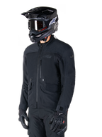Alpinestars St-7 Prime GORE-TEX Jacket, Black motorcycle jacket, worn by a rider with a black helmet and goggles, featuring large chest cargo pockets and a laminated waterproof shell, premium adventure touring and commuting gear.