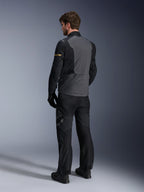 Alpinestars ST-7 2L GORE-TEX Jacket, Deep Gray and Black with Dark Khaki accents, rear view of a rider wearing the jacket and matching motorcycle pants, adventure touring gear with waterproof laminated construction