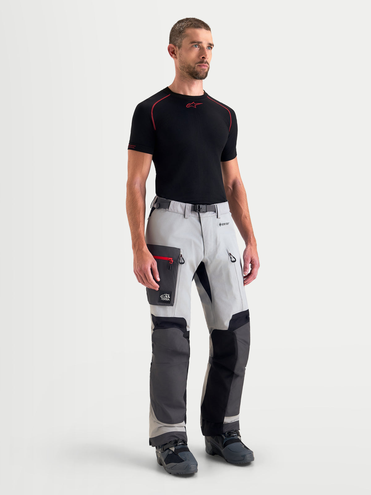 Alpinestars Arenis Gore-Tex Pants, men's adventure touring motorcycle pants in mid gray, deep gray, and black, front view on a model wearing waterproof textile riding apparel with cargo pockets.