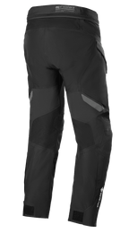 Pantalones Alpinestars ST-7 2L GORE-TEX, negro y gris oscuro, vista trasera, pantalones impermeables para motociclismo adventure touring con paneles reforzados, logotipo de GORE-TEX en la parte inferior de la pierna y correas de ajuste en los tobillos