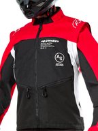 Chaqueta Alpinestars Pro-Dura, chaqueta de moto off-road, negro, rojo brillante y blanco, usada con un casco negro, con bolsillos con cremallera y logotipos llamativos en el pecho, construcción textil duradera para conducción de enduro y trail