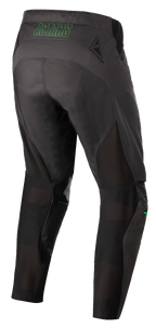 Pantalones Alpinestars Techstar Phantom, pantalones de motocross, antracita y verde neón, vista trasera con la marca 'ASTARS' en verde neón en la cintura, paneles de ventilación de malla en la parte posterior de las piernas y asiento reforzado para mayor durabilidad en carreras off-road