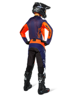 Motocross rider wearing complete racing gear from the back, Navy and orange jersey, Pro-Dura Pants in Navy Hot Orange White, black helmet and black boots, professional off-road racing outfit ensemble.