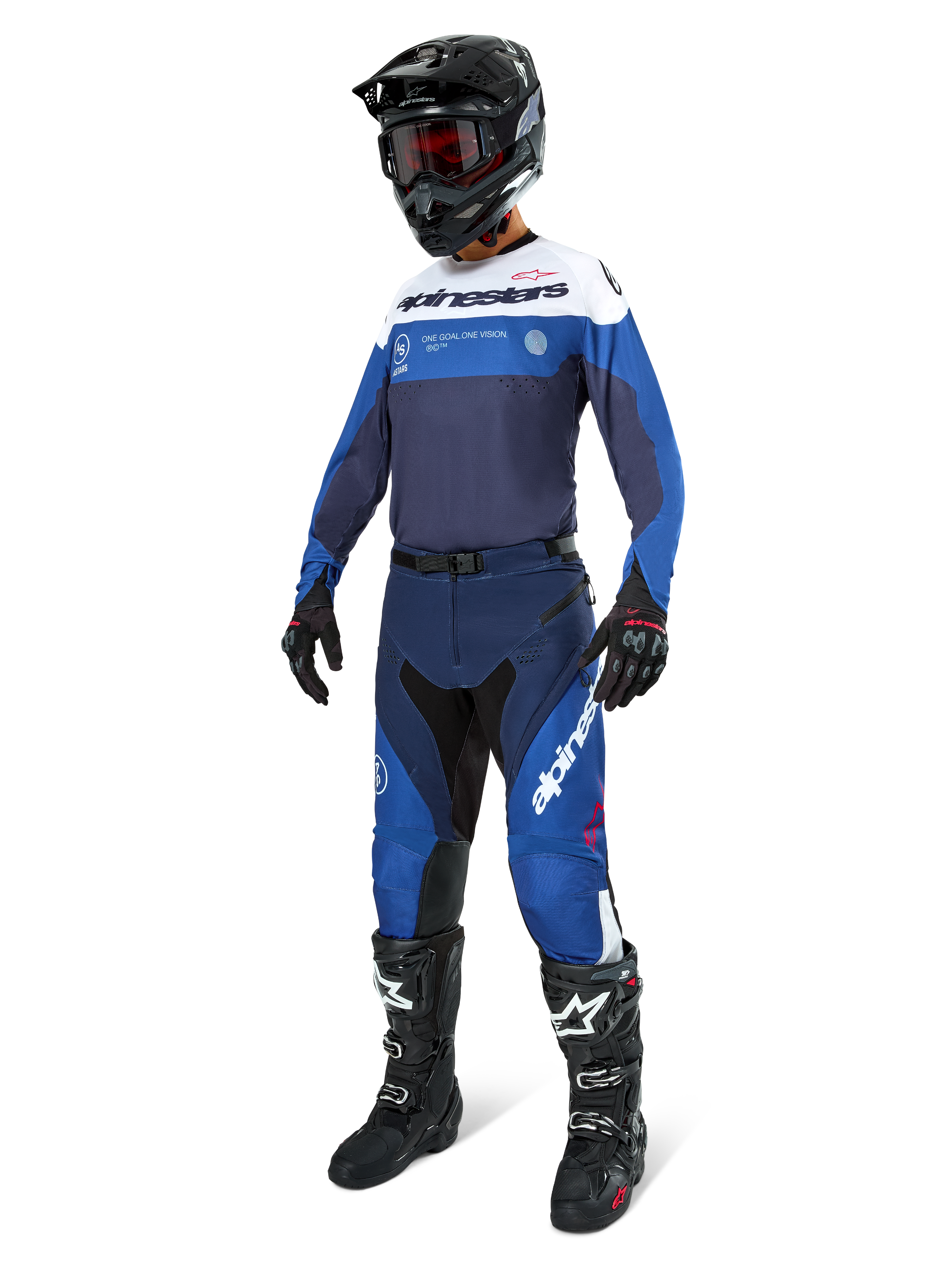 Motocross rider wearing Alpinestars Pro-Dura Pants in Navy, Bright Blue, and White, paired with a matching long-sleeve jersey, black helmet with red goggles, black gloves, and black and white boots, coordinated outfit for enduro and off-road racing.