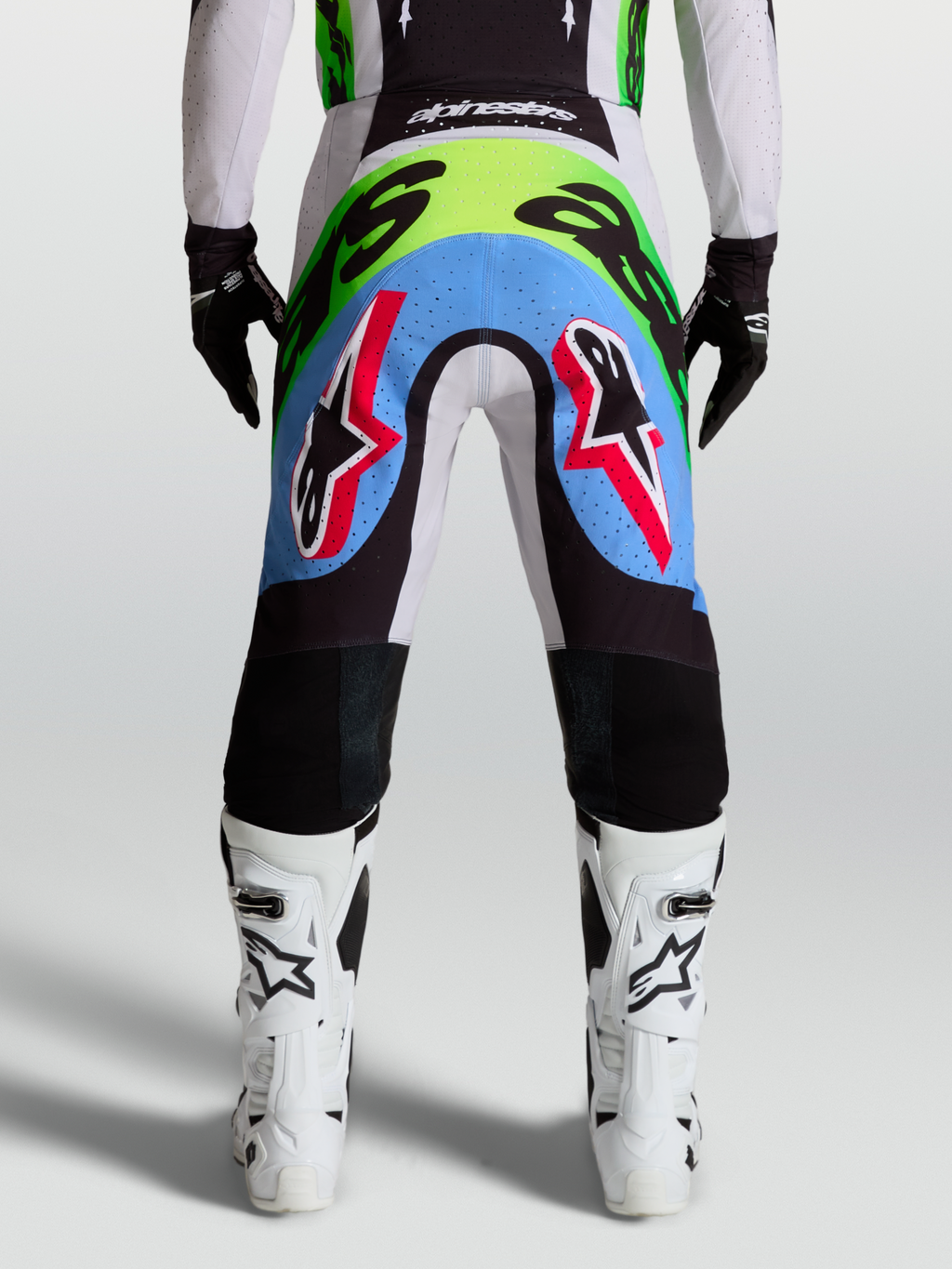Pantalones Alpinestars Supertech Dyna para motocross de hombre, lila y verde flúor, con paneles perforados, vista trasera