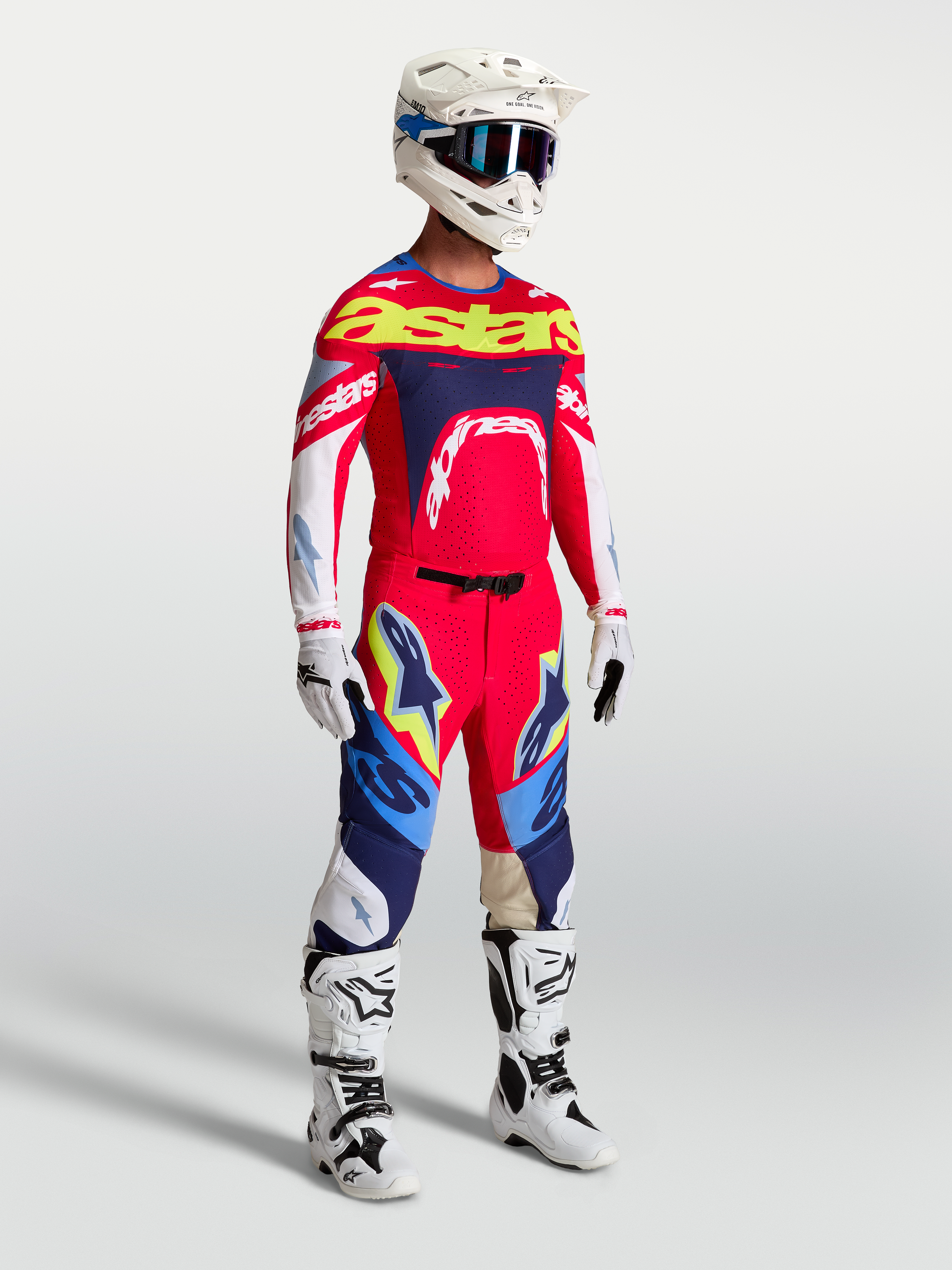 Alpinestars Supertech Dyna Pants, Fire Red and Navy Blue motocross gear set including racing jersey and white boots for men.