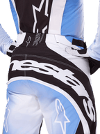 Alpinestars 2025 Techstar Melt Pants, Motocross Pants, Black White and Blue, close-up rear view featuring bold white branding on the seat, coordinated with matching Techstar Melt jersey and gloves, professional racing gear for motocross