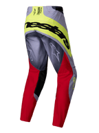 Alpinestars 2025 Techstar Melt Pants, pantalones de motocross, rojo brillante y gris con detalles en amarillo neón, vista trasera que muestra la gran marca Alpinestars en negro en el asiento, logotipos Astars en las piernas, diseño duradero multimaterial para carreras off-road