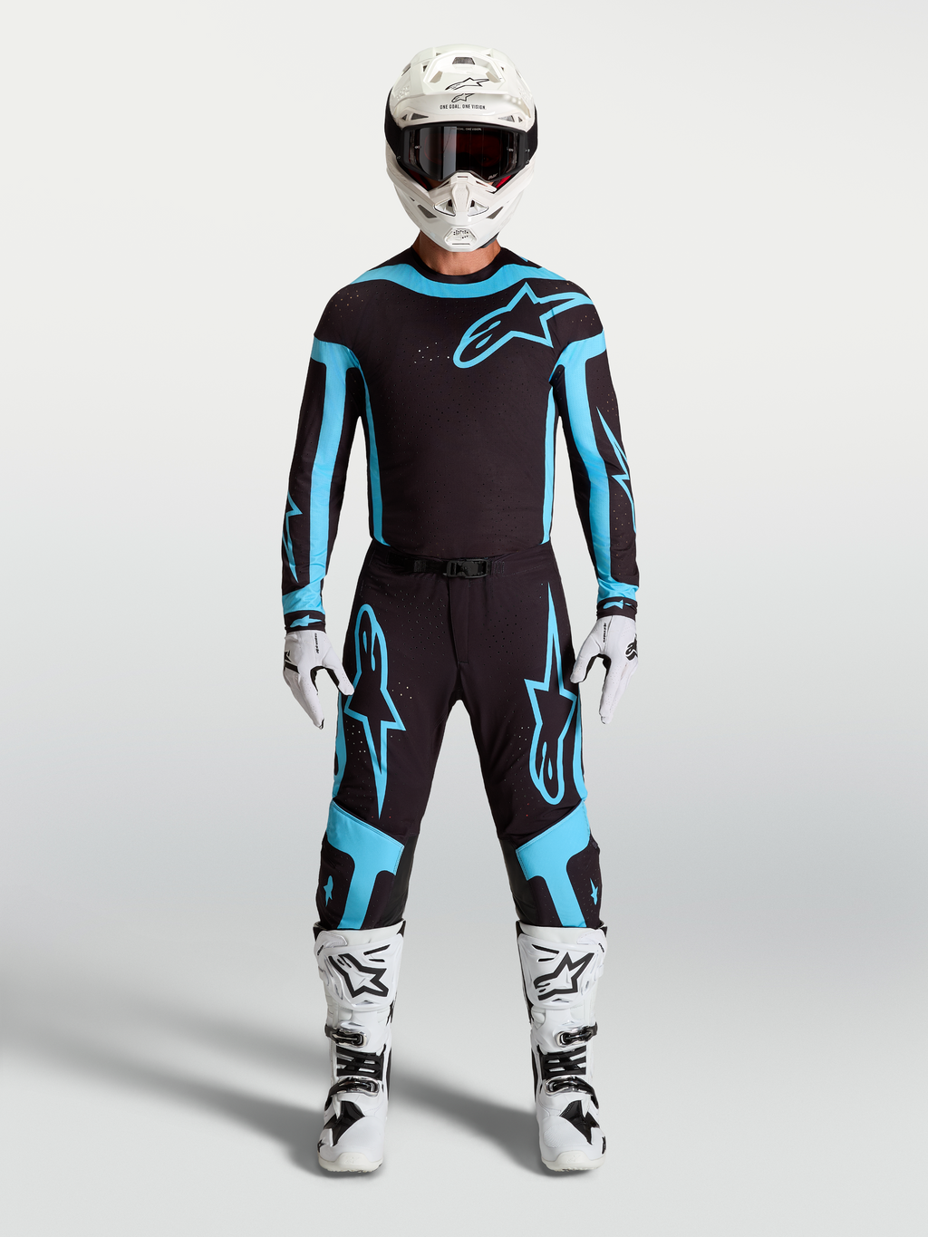 Alpinestars Supertech Vesta Pants, men's motocross racing gear in black and turquoise, featuring lightweight stretch construction on model.