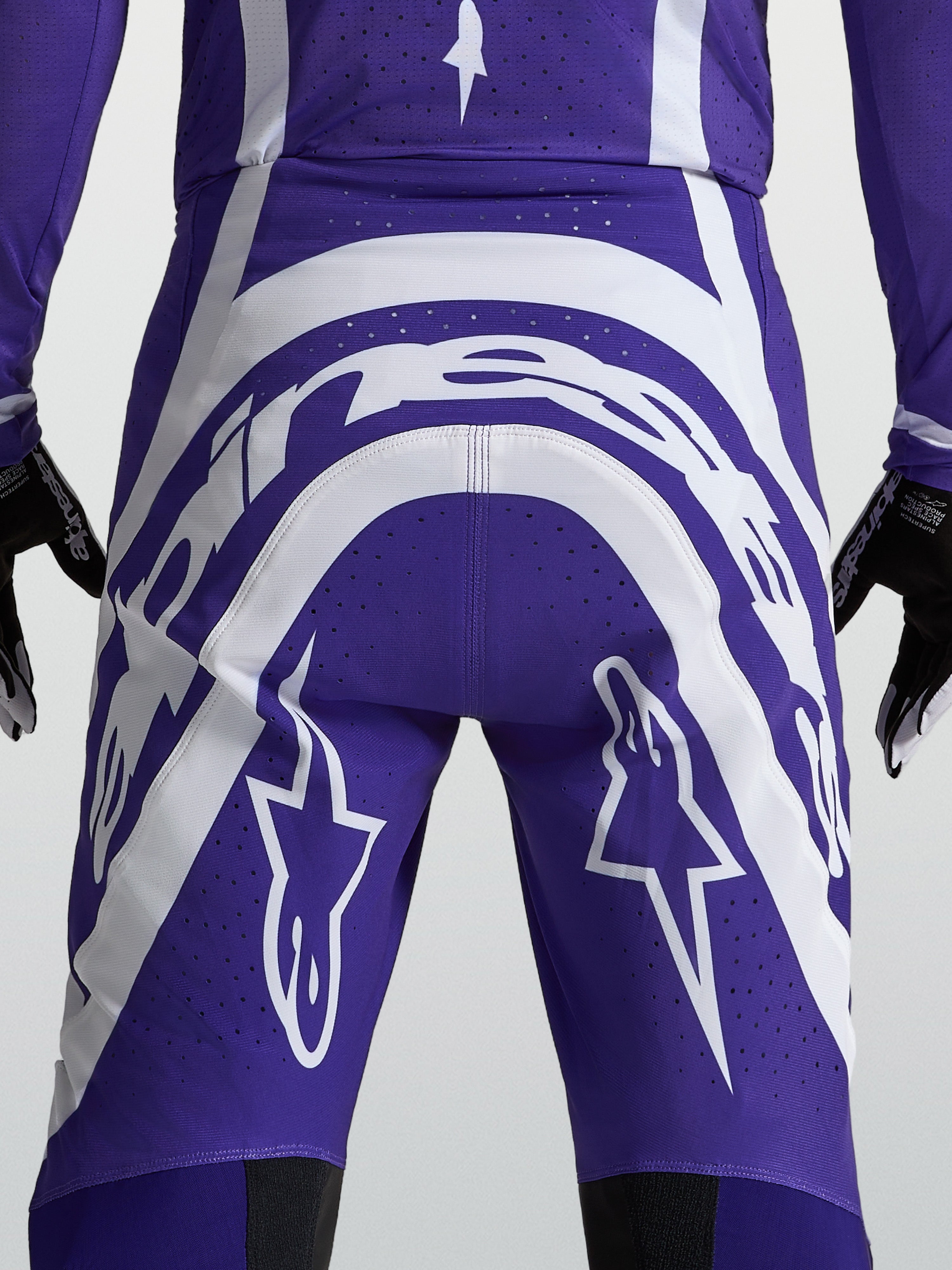 Pantalones Alpinestars Supertech Vesta, motocross para hombre, azul y blanco, vista trasera con logos y perforaciones