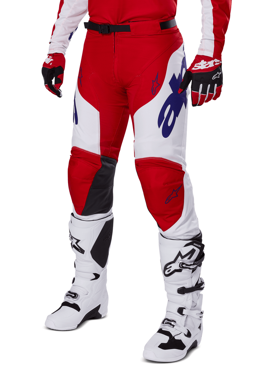 Alpinestars 2025 Racer Veil Pants, Motocross Pants, Bright Red and White, featuring blue Alpinestars logos and black leather inner knee panels, worn with matching red gloves and white motocross boots, coordinated gear set for off-road racing