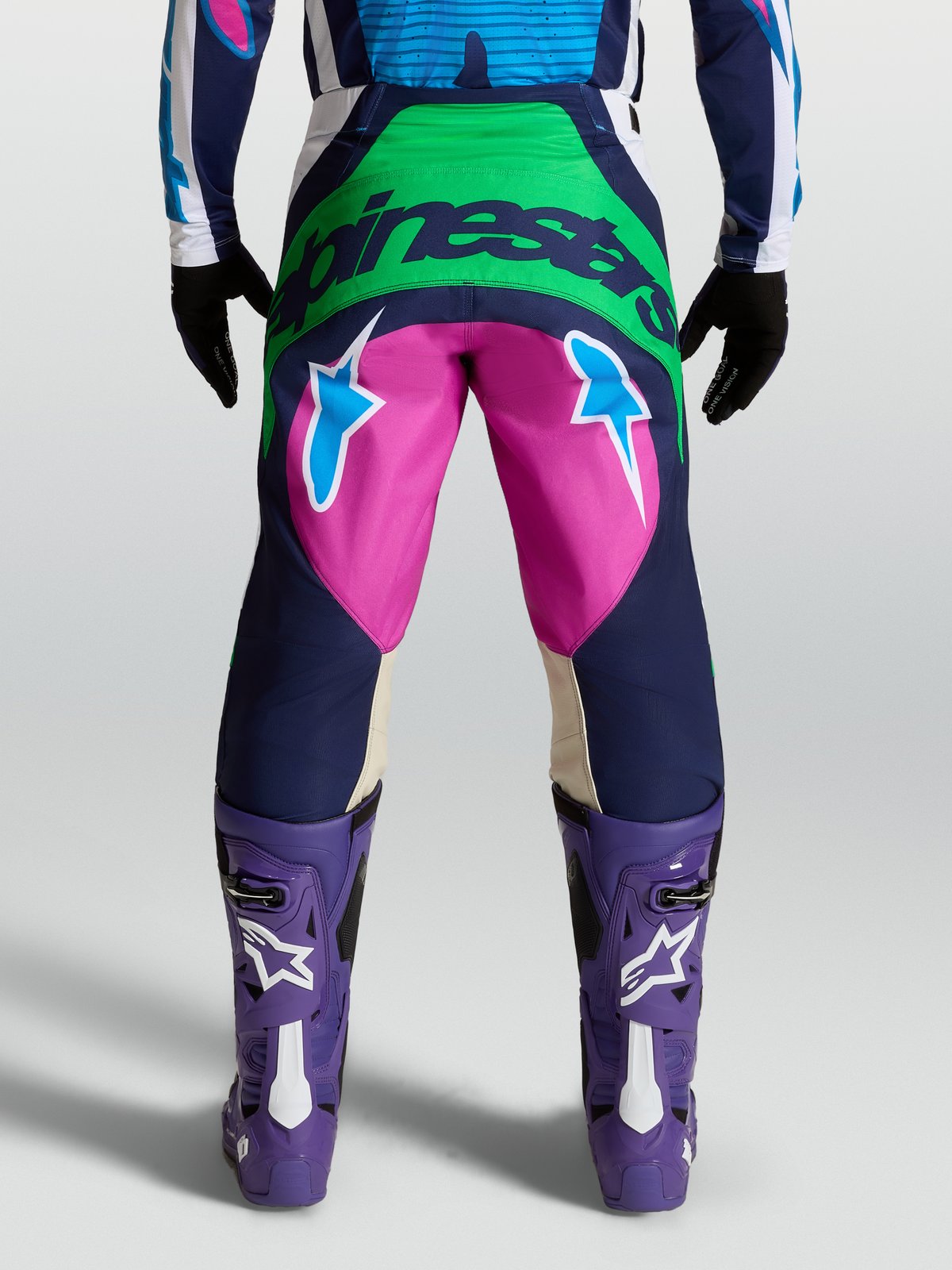 Alpinestars Techstar Maven Pants, Blue and Pink Motocross Pants on model with back view showing Alpinestars logo and star graphics.