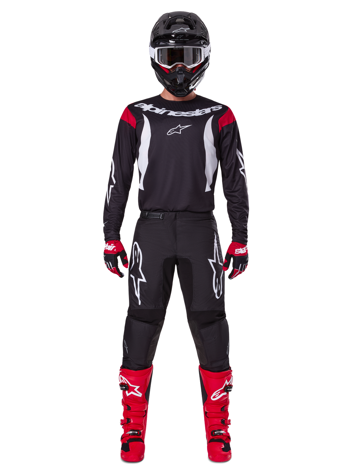 Alpinestars 2025 Fluid Haul Gear Set, Motocross rider in full racing gear, black jersey with red shoulder accents and white logos, black pants with white star branding, bright red boots, red and black gloves, black helmet with white goggles, coordinated off-road performance look