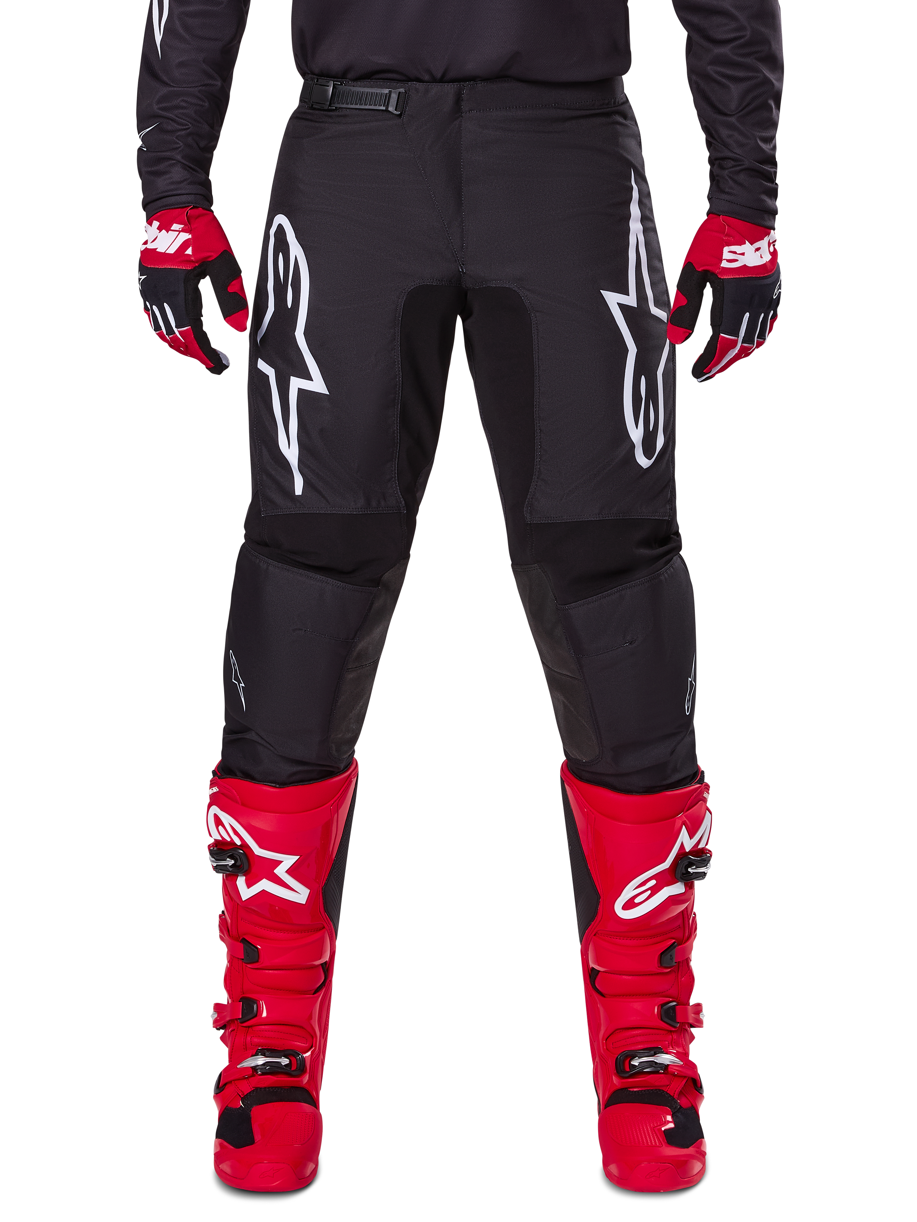 Alpinestars 2025 Fluid Haul Gear Set, Black Motocross Pants with white Astars logos on thighs, paired with vibrant red boots and red and black gloves, coordinated motocross outfit for off-road racing