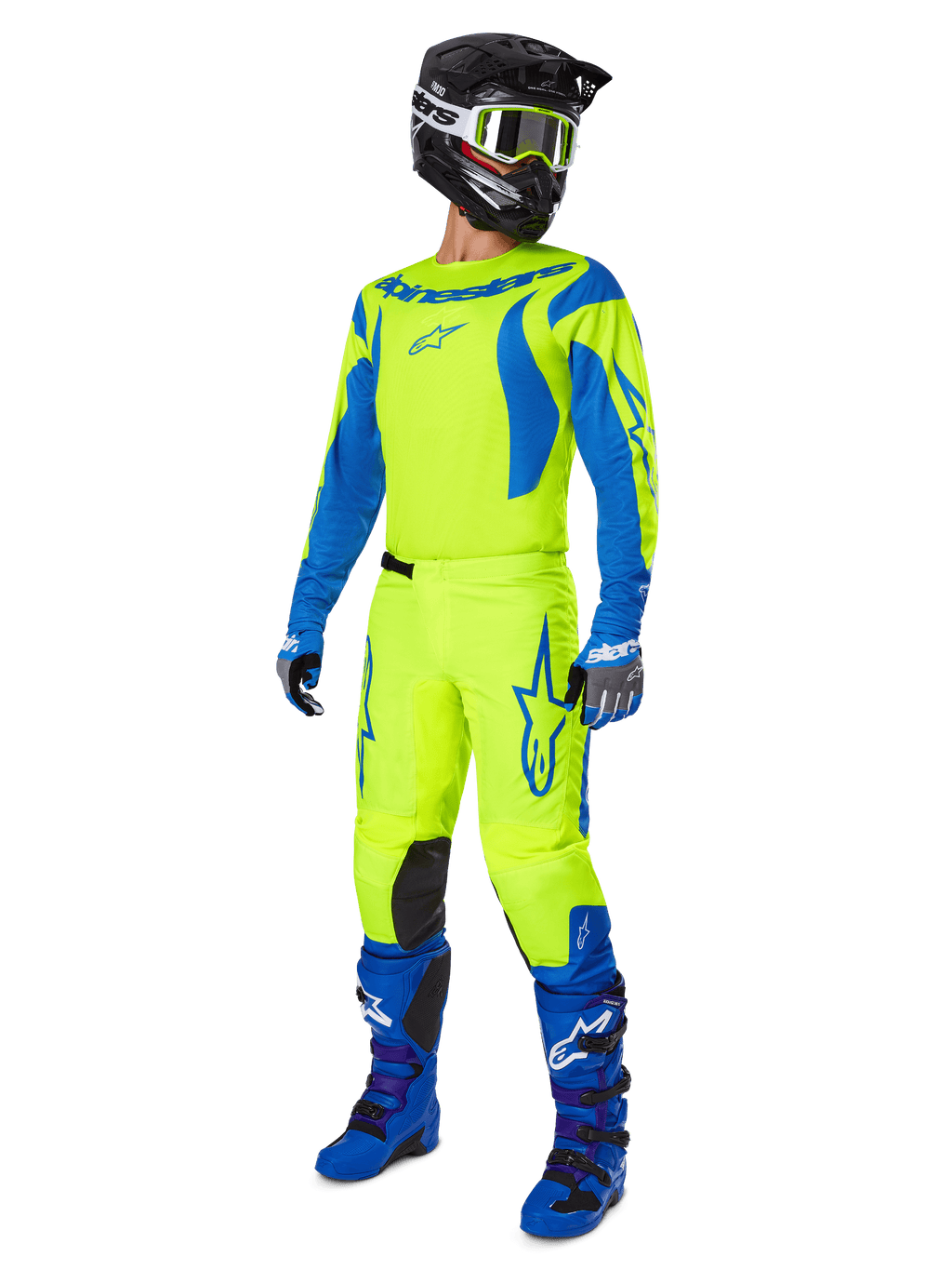 Alpinestars 2025 Fluid Haul Pants, pantalones de motocross, amarillo flúor y azul, usados como parte de un conjunto completo de equipamiento de carreras con jersey a juego, botas azules y casco negro, diseño de alta visibilidad para conducción todoterreno