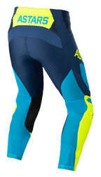 Alpinestars Techstar Factory Pants, pantalones de motocross, azul oscuro, amarillo flúor y azul neo brillante, vista trasera con la marca 'ASTARS' en la cintura, paneles de malla perforada para ventilación, parches negros en la parte interna de la pierna y ajuste de carrera precurvado para rendimiento en todoterreno.