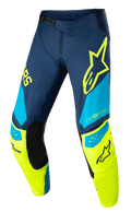 Alpinestars Techstar Factory Pants, pantalones de motocross, azul oscuro, amarillo flúor y azul claro, con paneles interiores negros en la rodilla, logotipo de estrella amarilla en el muslo, marca «ONE GOAL ONE VISION» y zonas de ventilación perforadas para alto rendimiento todoterreno