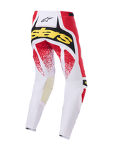 Alpinestars 2026 Techstar Nomur Pants, pantalones de motocross, blanco, rojo y negro, vista trasera con marca 'Stars' en amarillo y gráficos moteados en rojo, construcción duradera de múltiples paneles para carreras todoterreno
