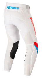 Pantalones Alpinestars Techstar Quadro, pantalones de motocross, blanco roto, azul neón y rojo brillante, vista trasera que muestra el logotipo 'ASTARS' en azul claro en la cintura, paneles de ventilación de malla, parche de cuero negro en el interior de la pierna y marca roja llamativa en el lateral.