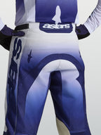 Alpinestars Racer Air Amber, pantalones de motocross, vista trasera, azules y blancos, logotipo astars en la cintura.