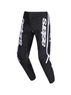 Alpinestars 2026 Fluid Apex Pants, pantalones de motocross, negros y grises, con el logotipo astars vertical en blanco en las piernas, diseño ergonómico de ajuste deportivo precurvado, fabricación duradera en polifabric 600D para conducción off-road