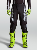 Alpinestars 2027 Fluid Apex V2 Men's Motocross Pants in Black and Silver, featuring ergonomic stretch panels on-model.