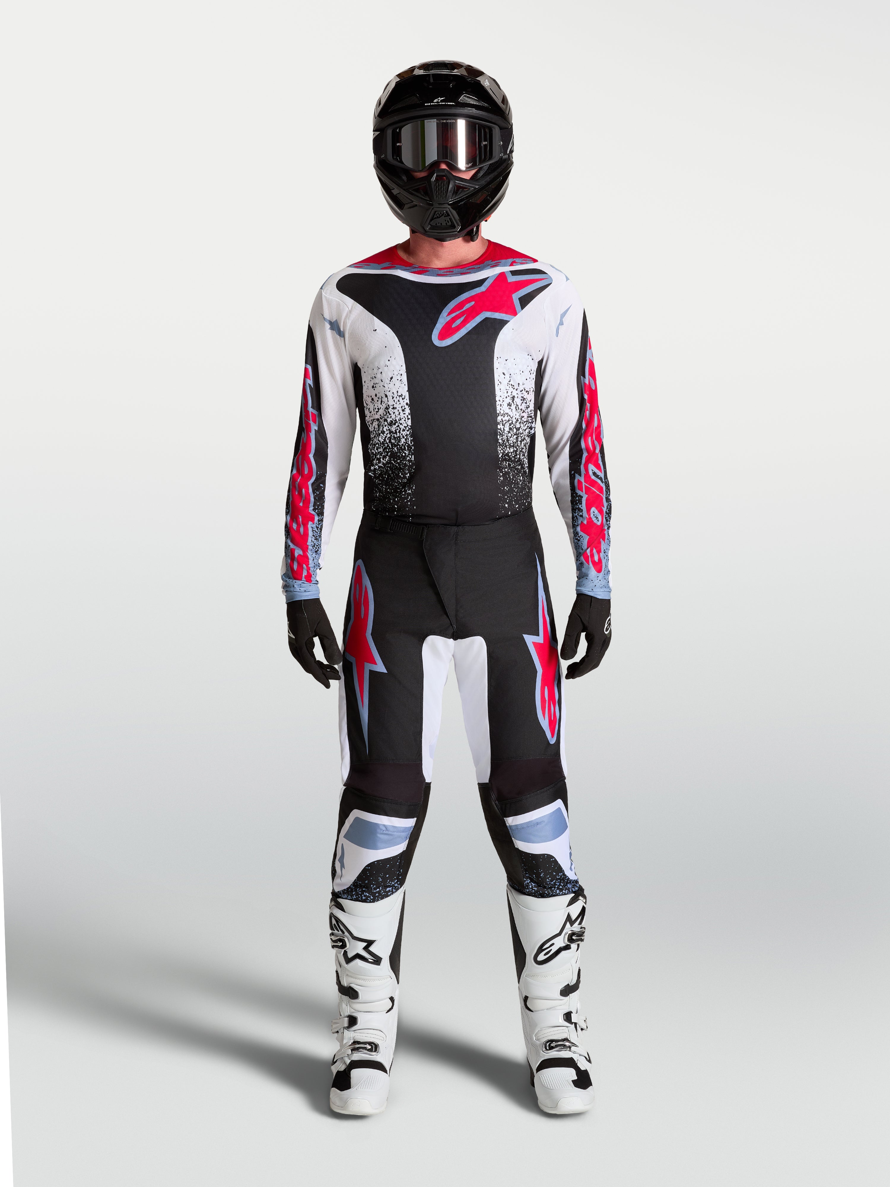 Alpinestars pantalones Fluid Drag para hombre, pantalones de motocross en negro, blanco y rojo fluo con ajuste ergonómico.