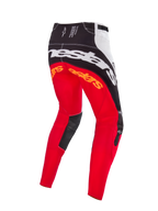 Pantalones de motocross Alpinestars Techstar Deep Edición Limitada, en color negro, blanco y rojo intenso, vista posterior con gran marca Alpinestars blanca en el asiento, logotipos naranjas en la parte superior de las piernas y paneles de cuero negro en el interior de las rodillas, diseñados para competición profesional off-road.